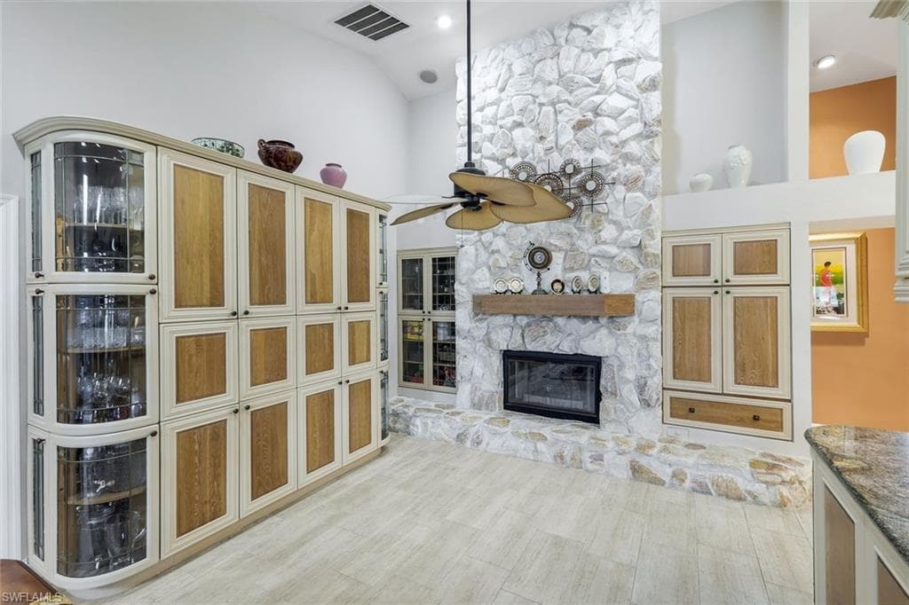 Custom Tile Flooring, Cabinetry, Spectacular Floor to Ceiling Stone, Gas Fireplace with Mantel, Hearth, Tile Floor that looks like wood.