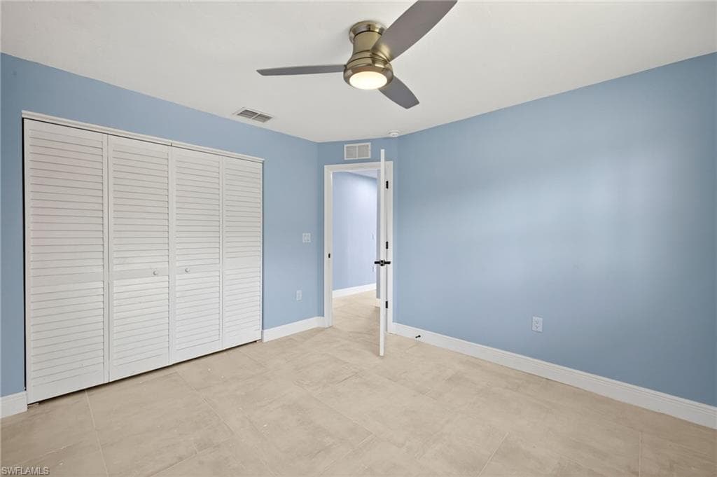 Bedroom #3 featuring tile flooring and light blue walls
