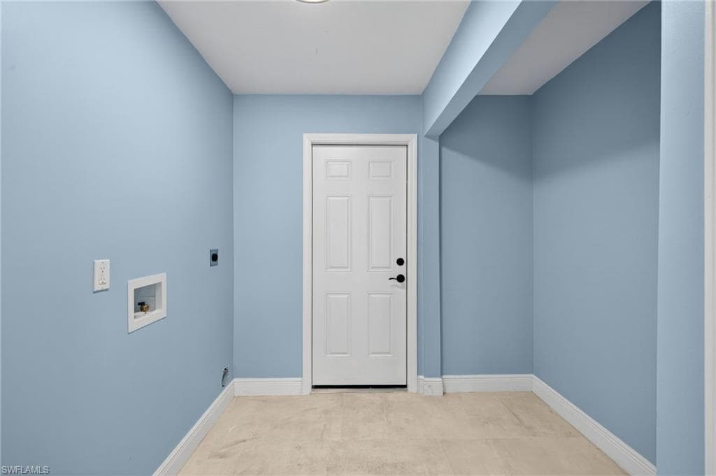 Utility area with light blue walls and off-white flooring