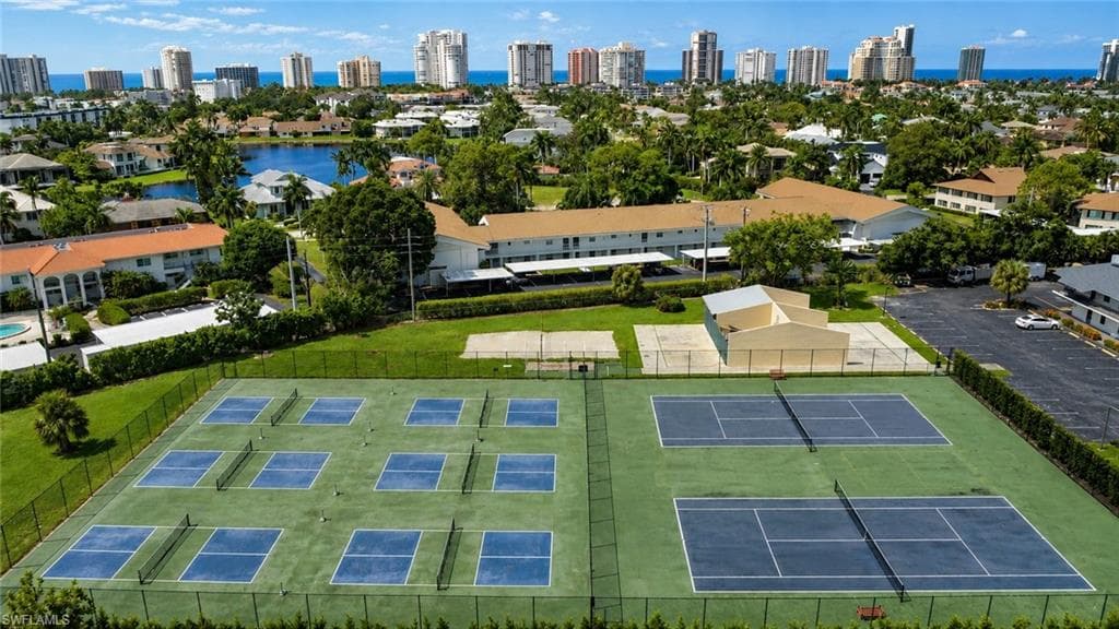 Expansive recreational area featuring multiple pickleball courts and two tennis courts