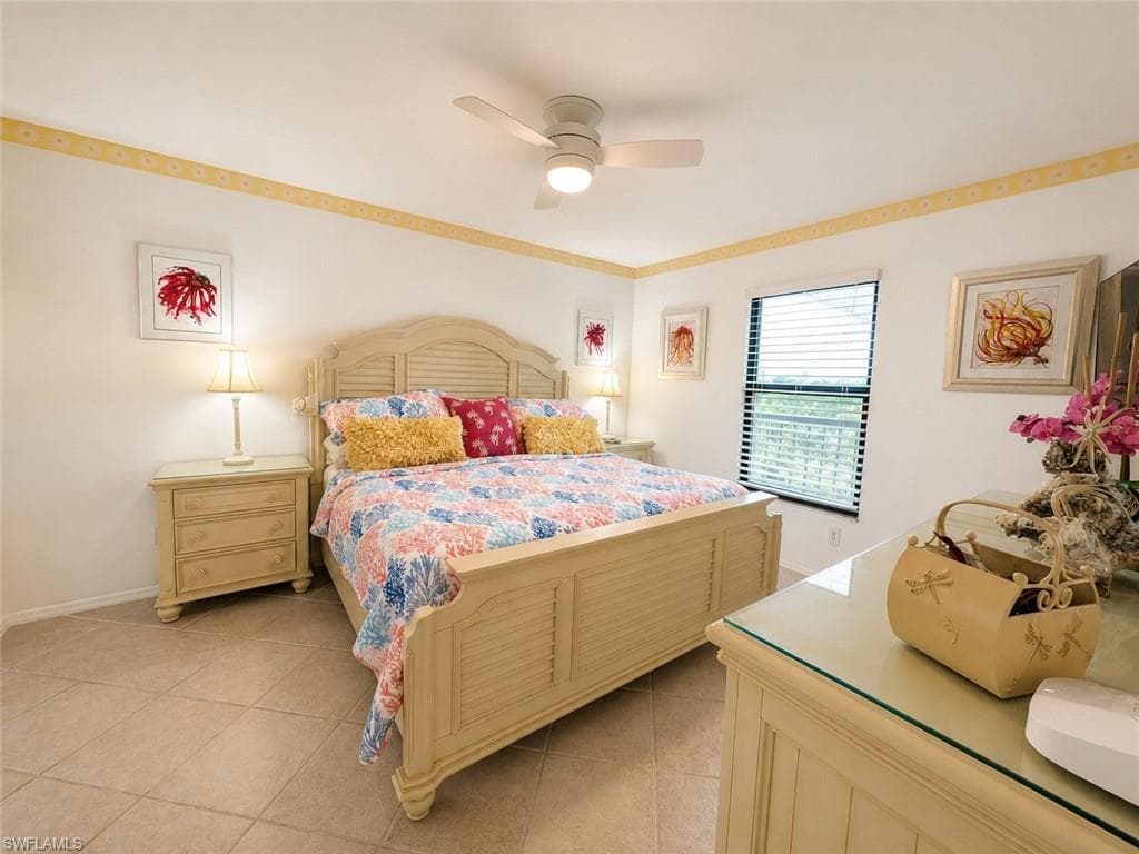 Spacious room featuring tile flooring, a window with horizontal blinds, and a ceiling fan with integrated lighting