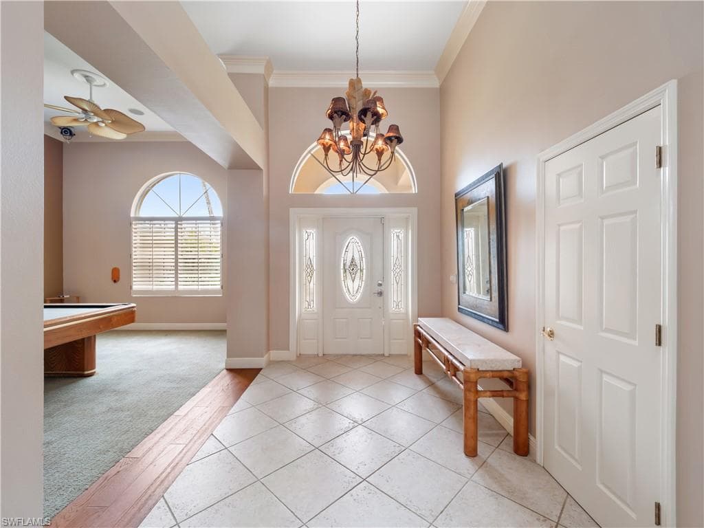Welcoming entry foyer with soaring ceilings and abundant natural light, creating an immediate sense of openness upon arrival.