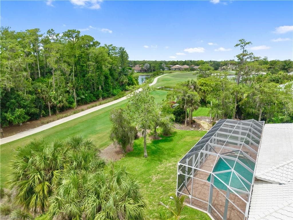Enjoy a premium golf course location overlooking the 13th hole of the Loch Ness Golf Course, where a picturesque golf cart path, mature trees, and generous setbacks enhance the sense of space and privacy.