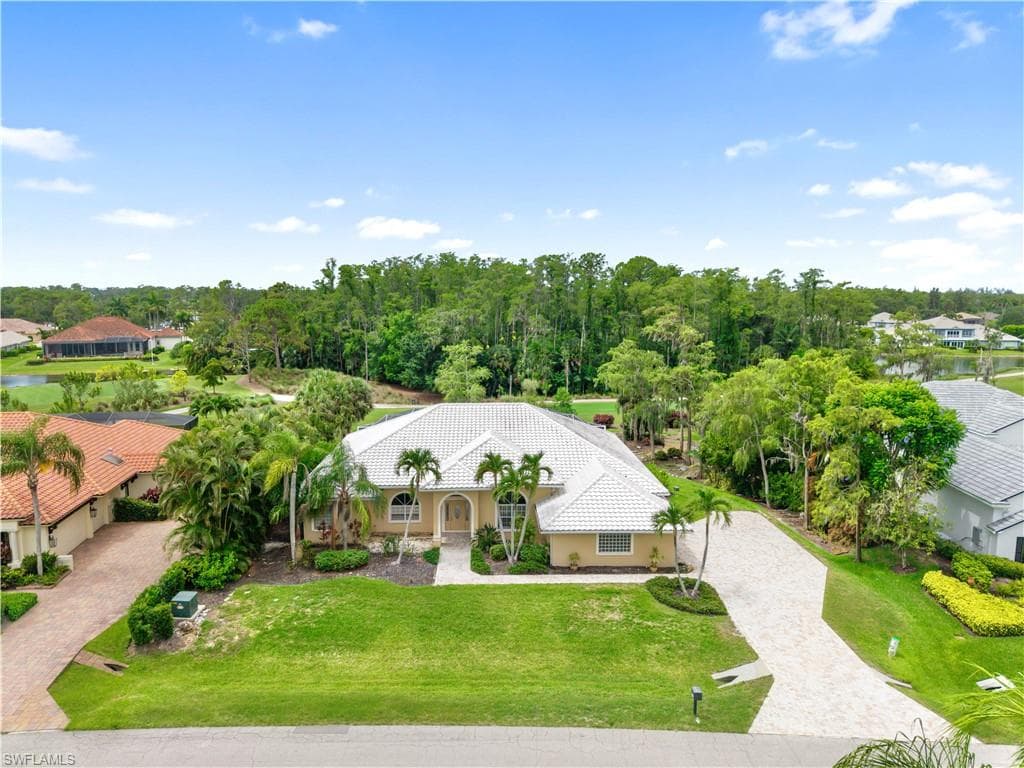 Aerial view showcasing the home's premium location overlooking the 13th hole of the renowned Loch Ness Golf Course, offering exceptional privacy, mature landscaping, and one of the most desirable golf course settings in Fiddlesticks Country Club.