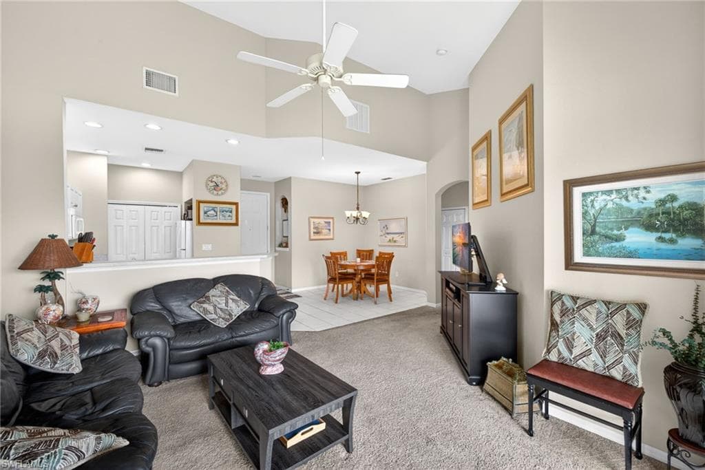 Open-concept living space featuring vaulted ceilings and a ceiling fan