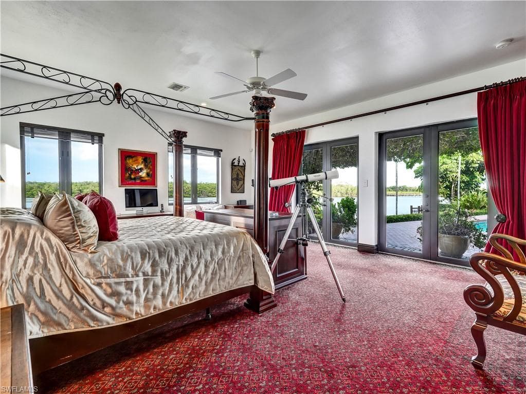 Spacious room featuring multiple windows and glass doors, offering water frontage