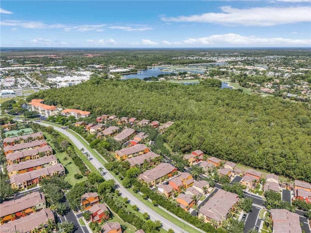 Aerial view of property's location featuring a large body of water and nearby suburban area