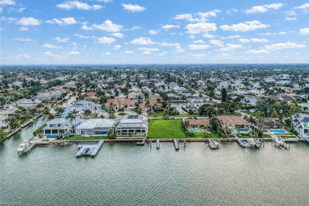 Aerial view of residential area featuring a large body of water