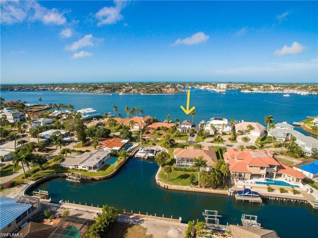 Aerial perspective of suburban area featuring a large body of water