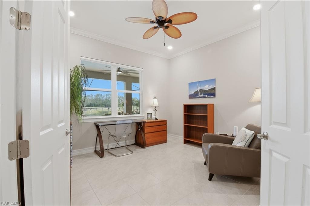 Spacious den with view to the gorgeous lanai, pool and picturesque golf course.