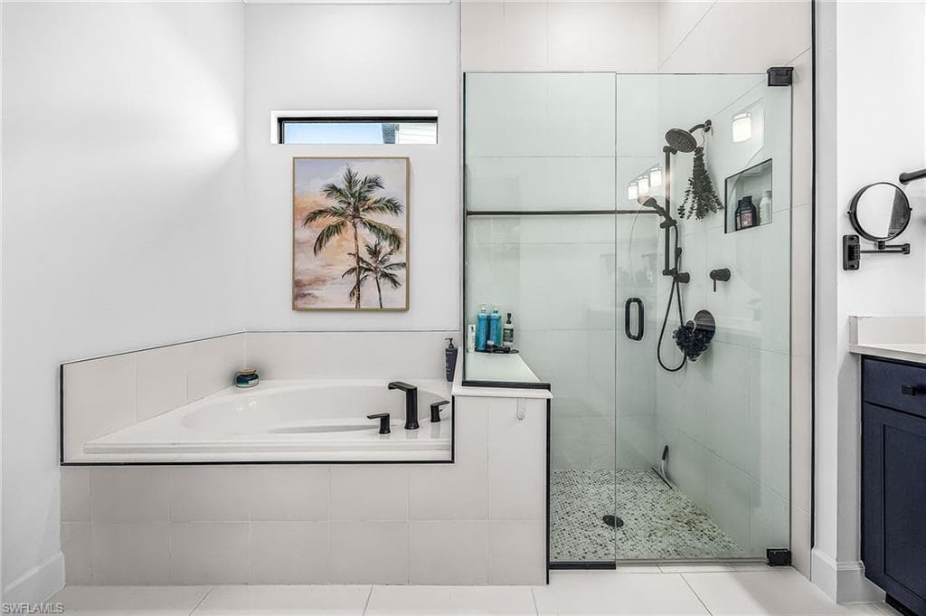 Full bath featuring a bath, a stall shower, and vanity