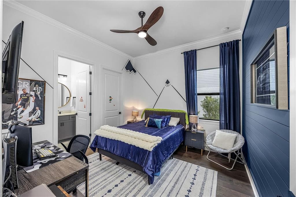 Bedroom with crown molding, ceiling fan, wood finished floors, and ensuite bath
