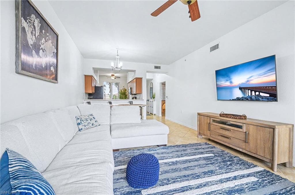 Comfortable living room offering open sightline to kitchen and lanai.