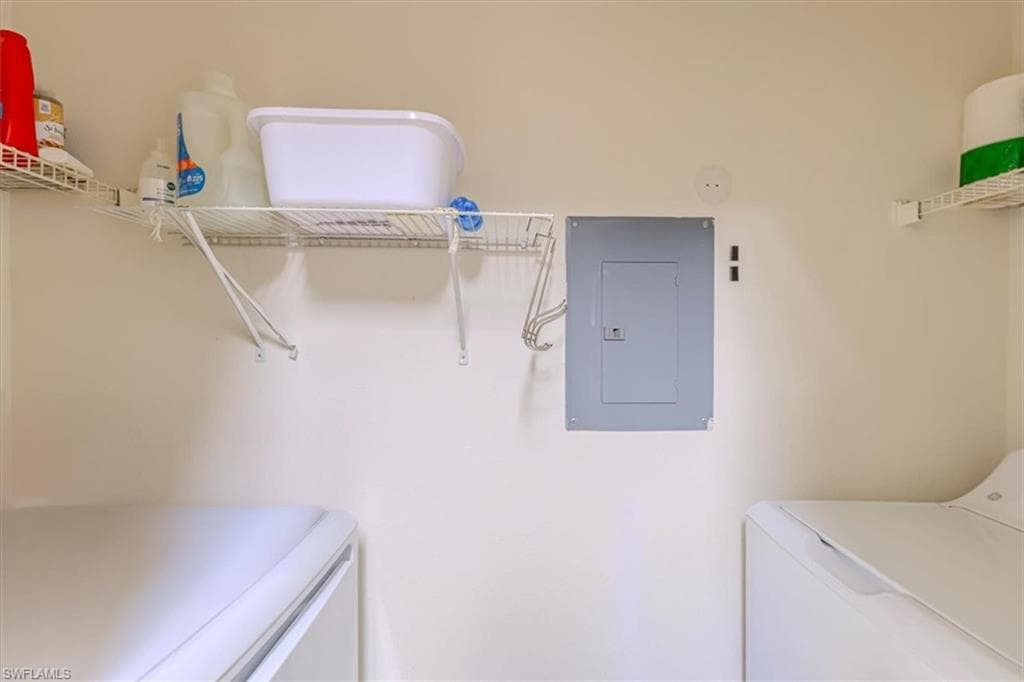 Washroom featuring electric panel and separate washer and dryer