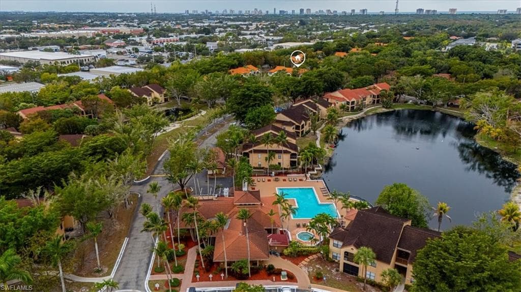 Drone / aerial view of a nearby body of water and city skyline