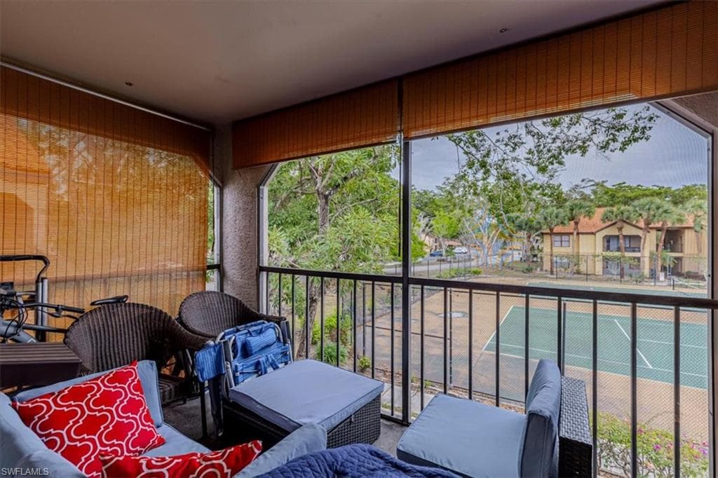 Balcony featuring a sunroom