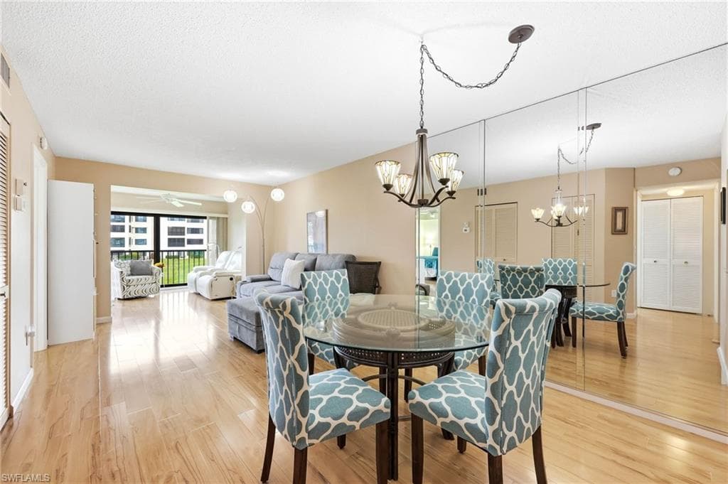 Open concept living and dining area featuring wood-finish flooring throughout