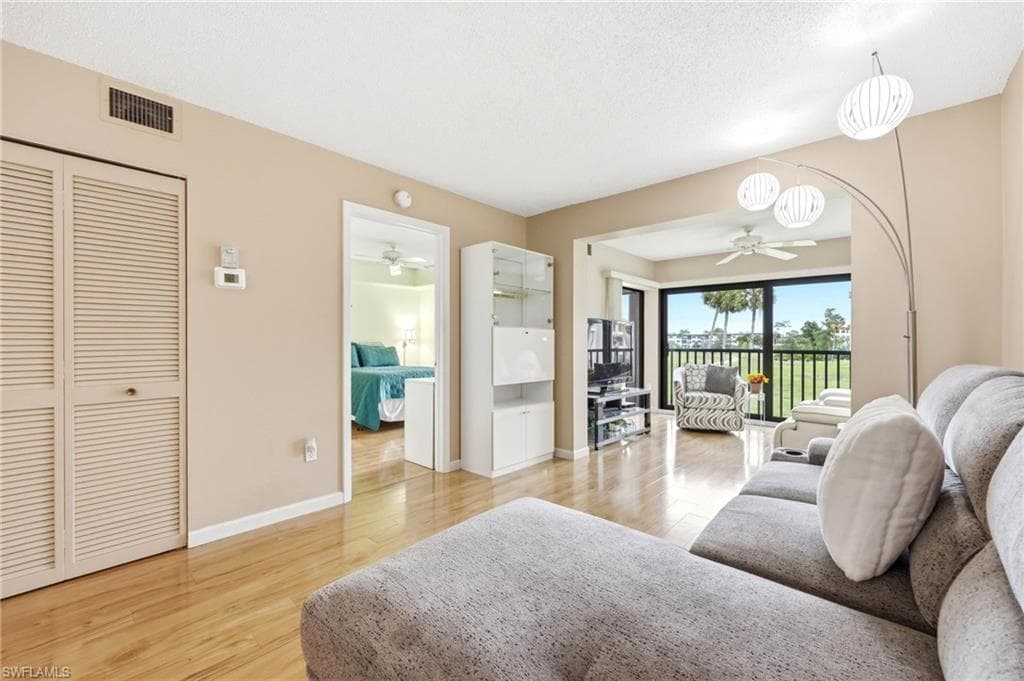 Living area with wood-finish flooring and neutral wall tones