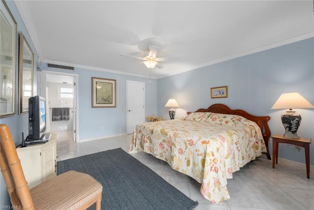 Primary bedroom suite with a walk-in closet, bathroom, and tile flooring