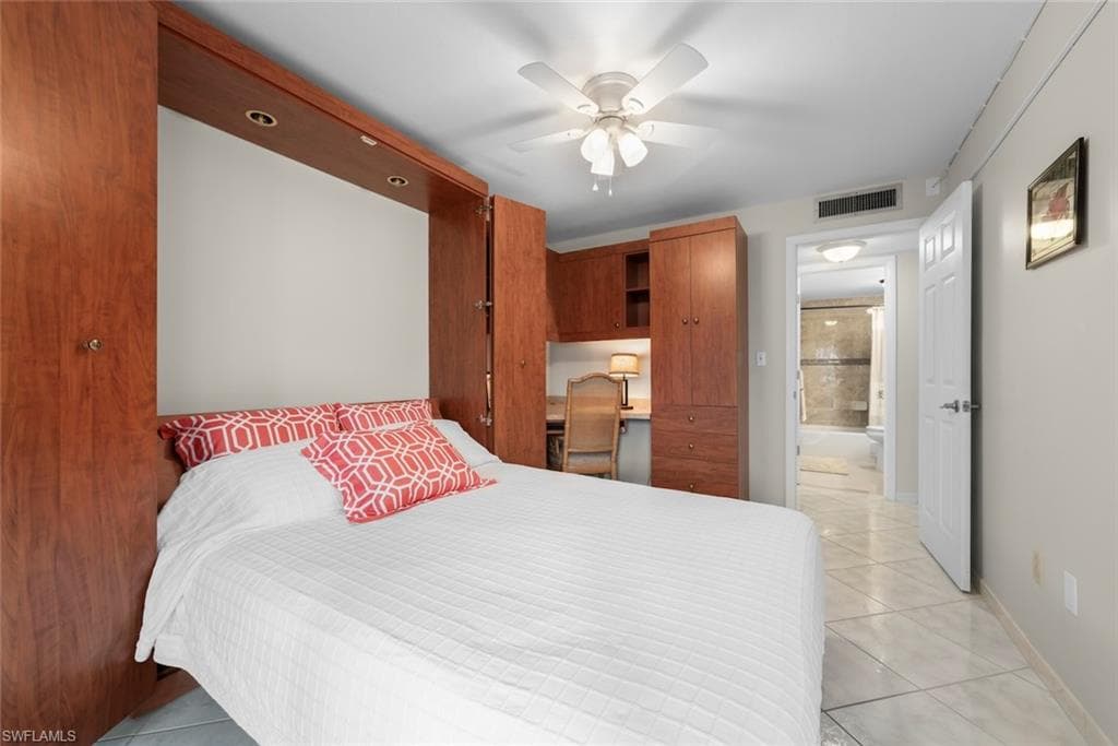 Guest bedroom with an integrated Murphy's Bed system with recessed lighting, built-in desk, and ample storage cabinetry for office space