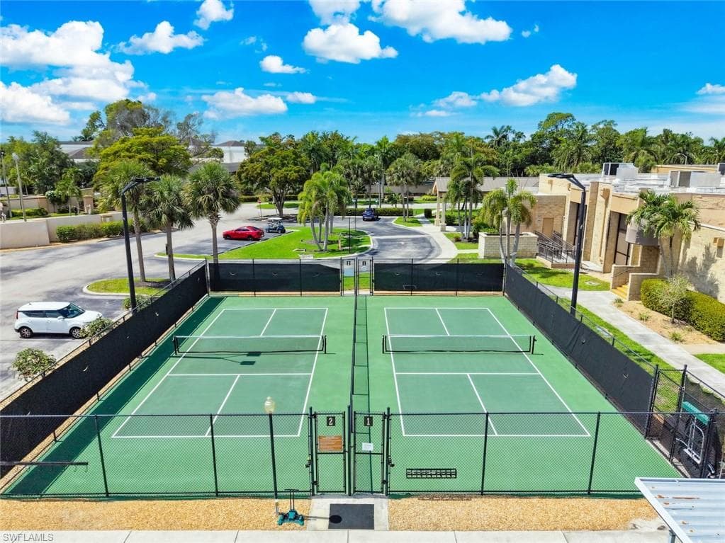 Dual pickle ball courts featuring green surfacing and black perimeter fencing