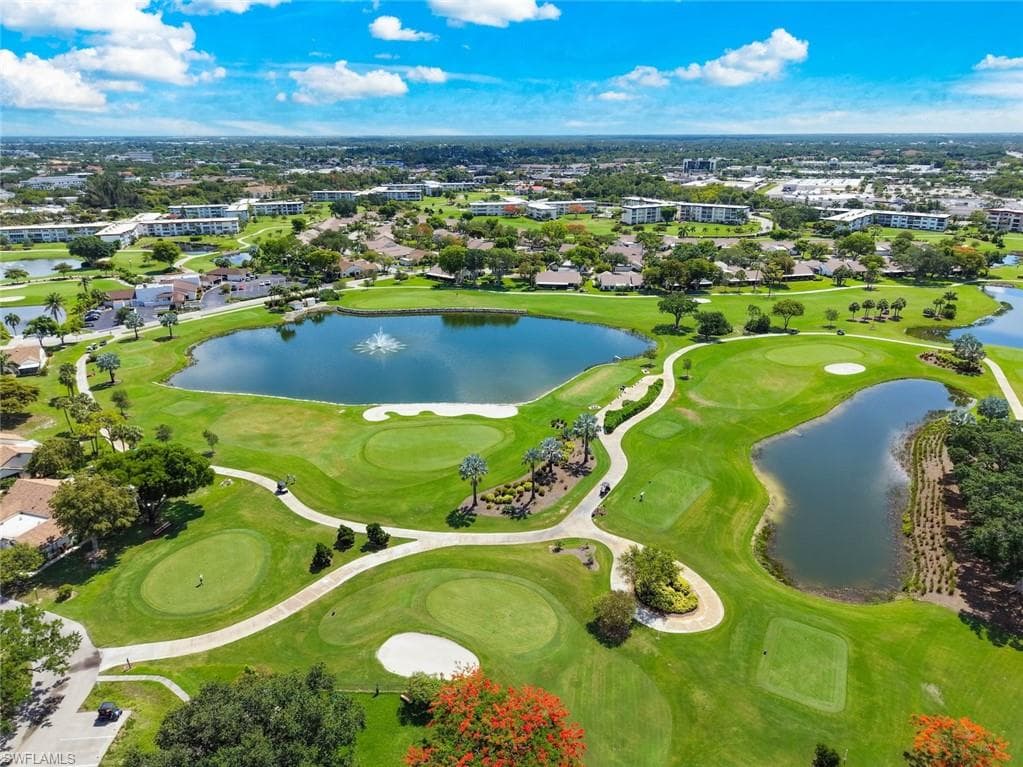 Aerial perspective showcasing a lush golf course with greens, fairways, and sand traps