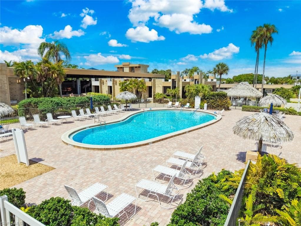 Community pool area featuring a swimming pool with paver decking