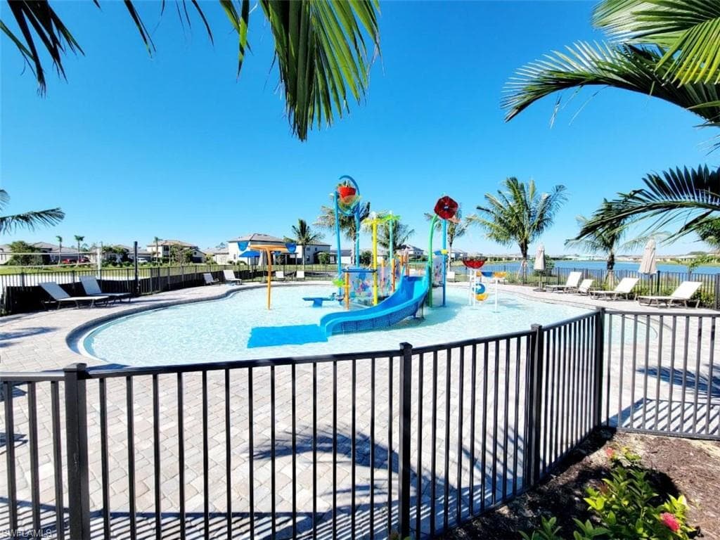 Community pool featuring a water play area and a patio