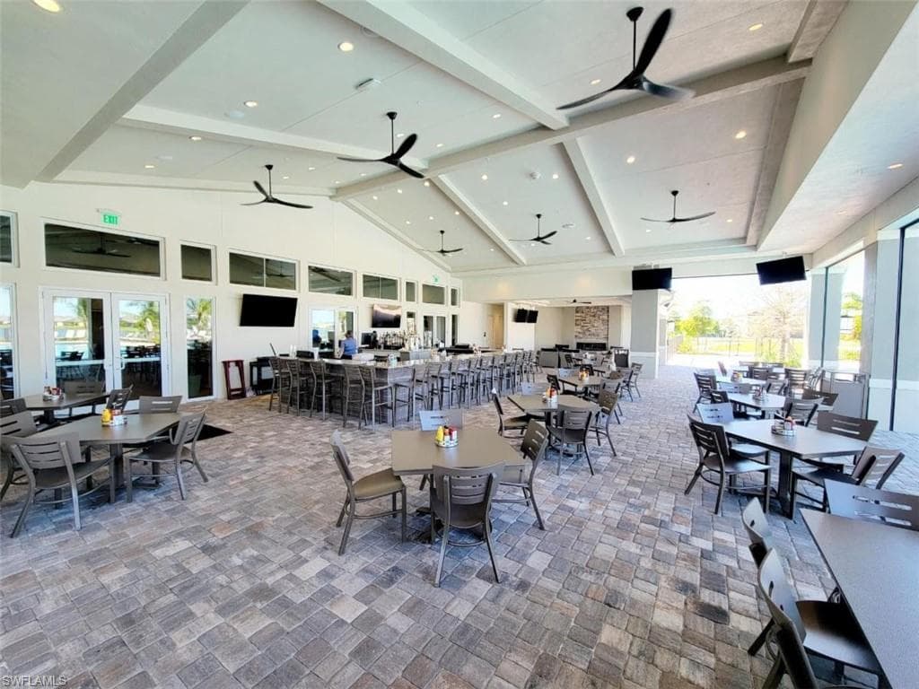 View of patio / terrace featuring ceiling fan, outdoor dining space, and exterior bar