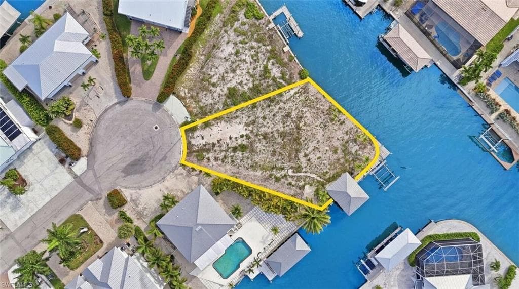 Waterfront lot with direct canal access, featuring a cul-de-sac location and an adjacent boat lift