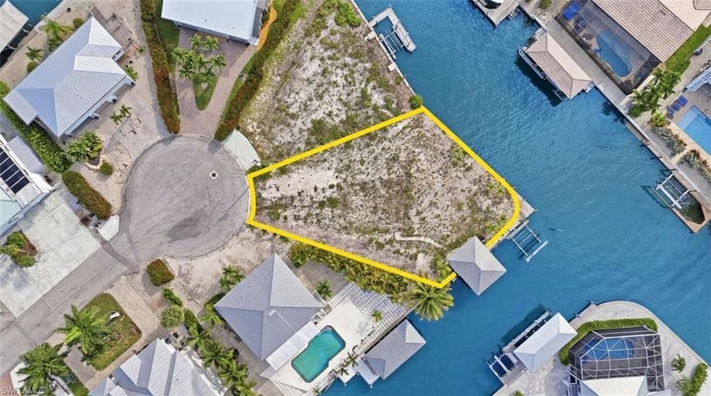 Vacant land parcel featuring waterfront access and a cul-de-sac location - Virtually Edited Image