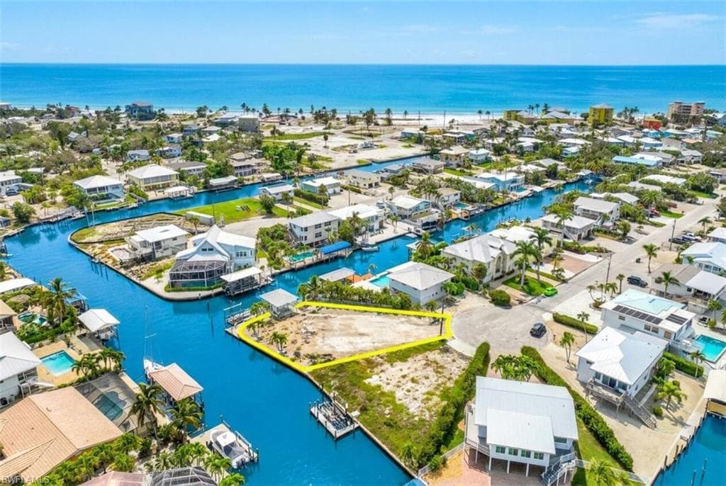 Waterfront parcel with direct canal access, surrounded by residential properties and established infrastructure - Virtually Edited Image