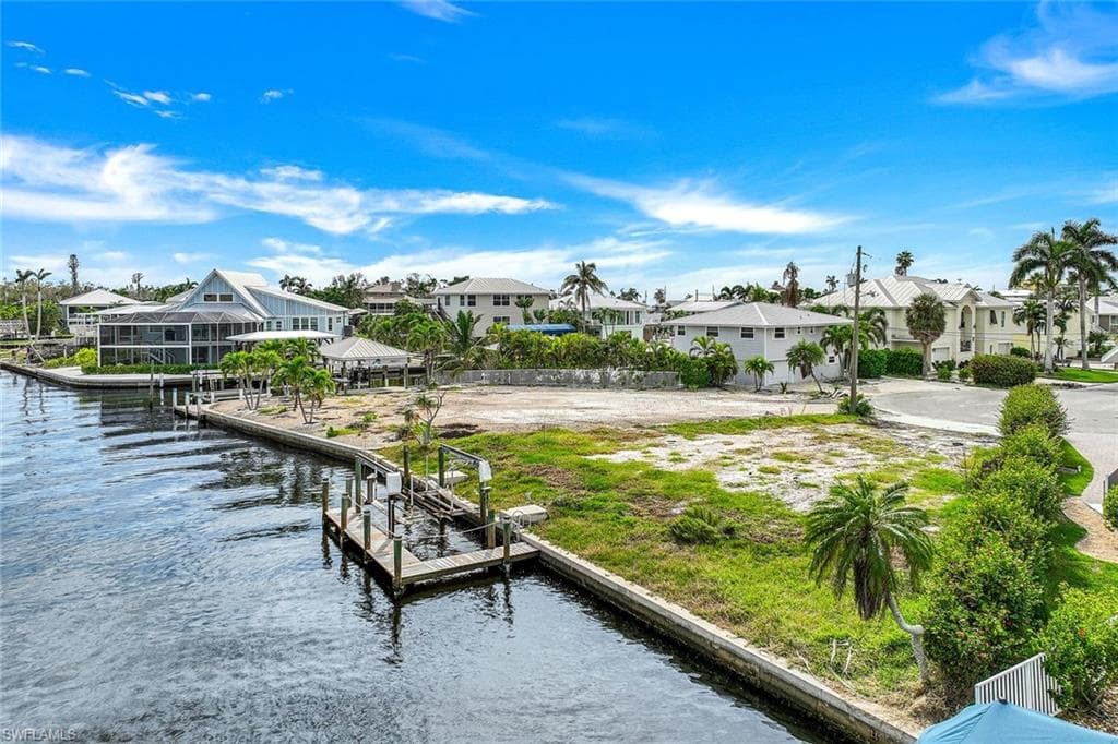 Waterfront lot featuring a private dock and a concrete seawall - Virtually Edited Image