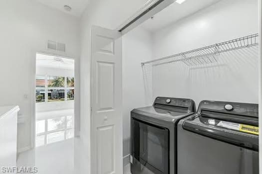 Washroom featuring washer and dryer and ceiling fan