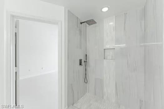 Bathroom featuring a marble finish shower