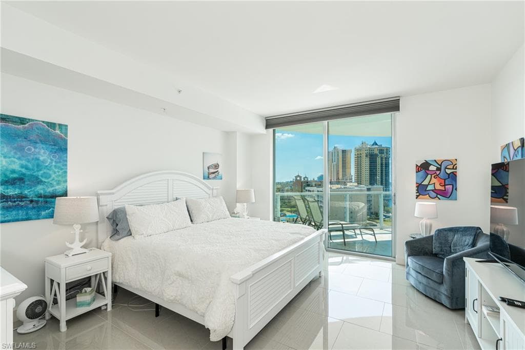 master bedroom with private balcony offering river and pool views