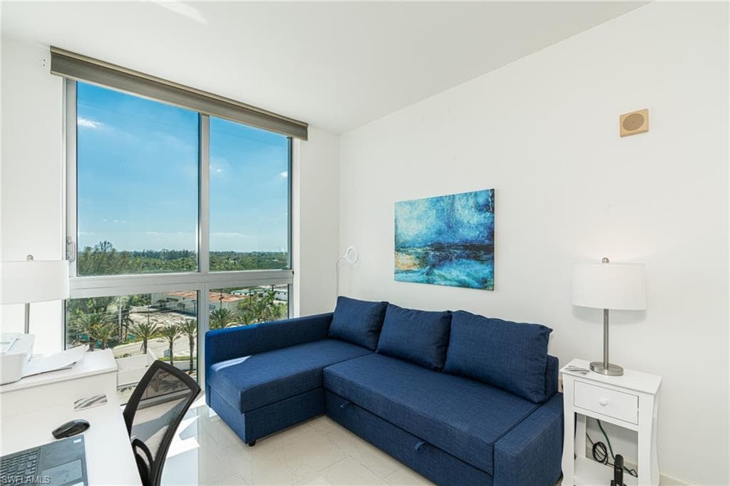 Den with floor to ceiling windows
