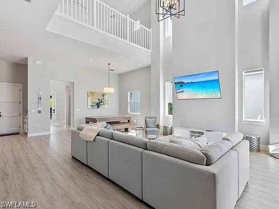 Expansive living area featuring soaring ceilings and light wood-finish flooring