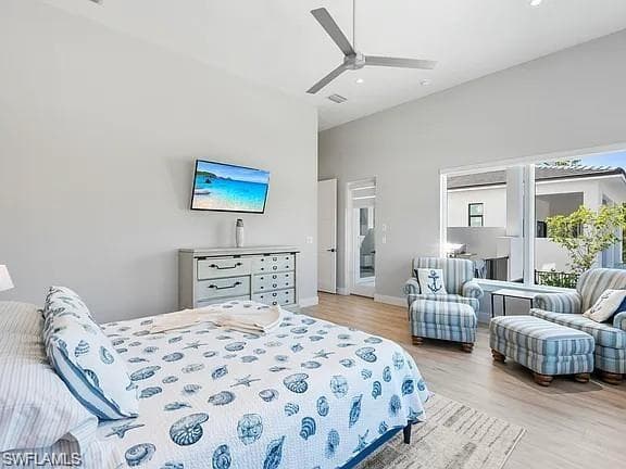 Spacious interior featuring high ceilings, wood-finish flooring, and a large sliding glass door