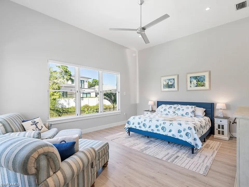 Vaulted ceiling with a contemporary ceiling fan and recessed lighting