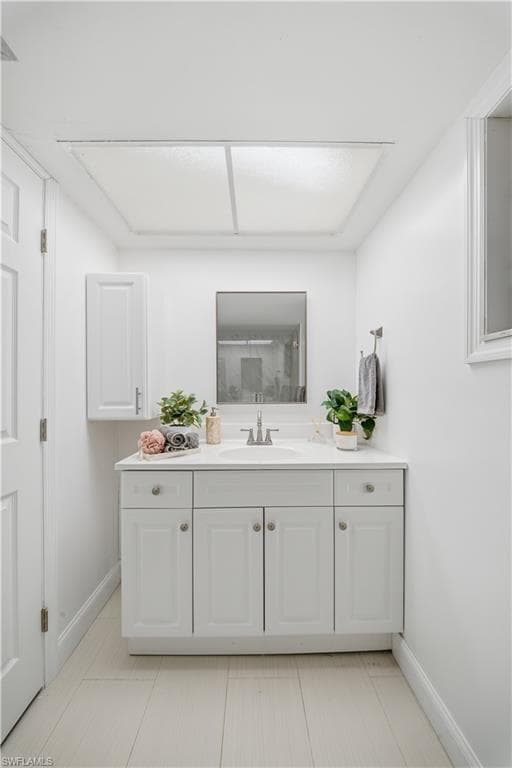 White vanity with undermount sink, ample storage cabinetry, and sleek hardware