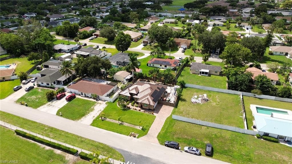 Expansive residential lot with mature landscaping and a partial perimeter fence