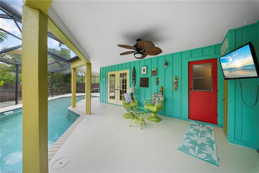 Screened lanai featuring a ceiling fan, direct pool access, and two sets of double French doors
