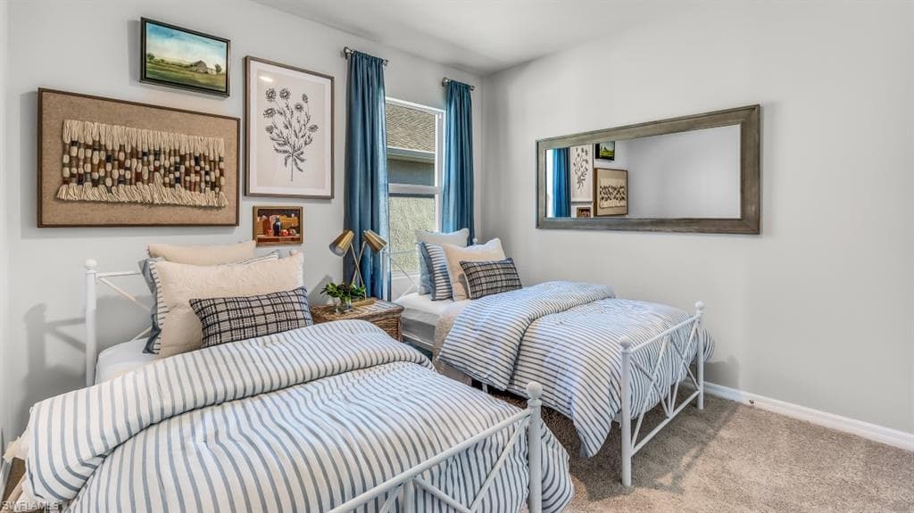 Model home. Carpeted bedroom featuring baseboards