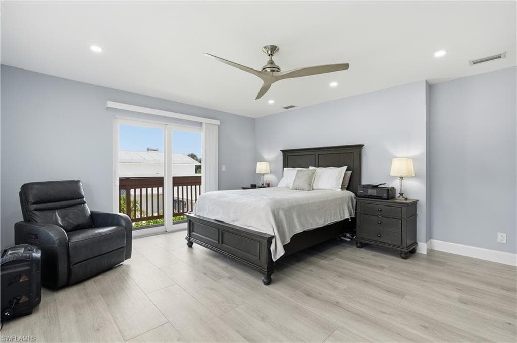 Spacious interior featuring light wood-finish flooring, recessed ceiling lighting, and a modern ceiling fan