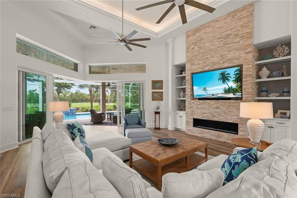 Spacious interior featuring high vaulted ceilings with tray detailing and multiple ceiling fans