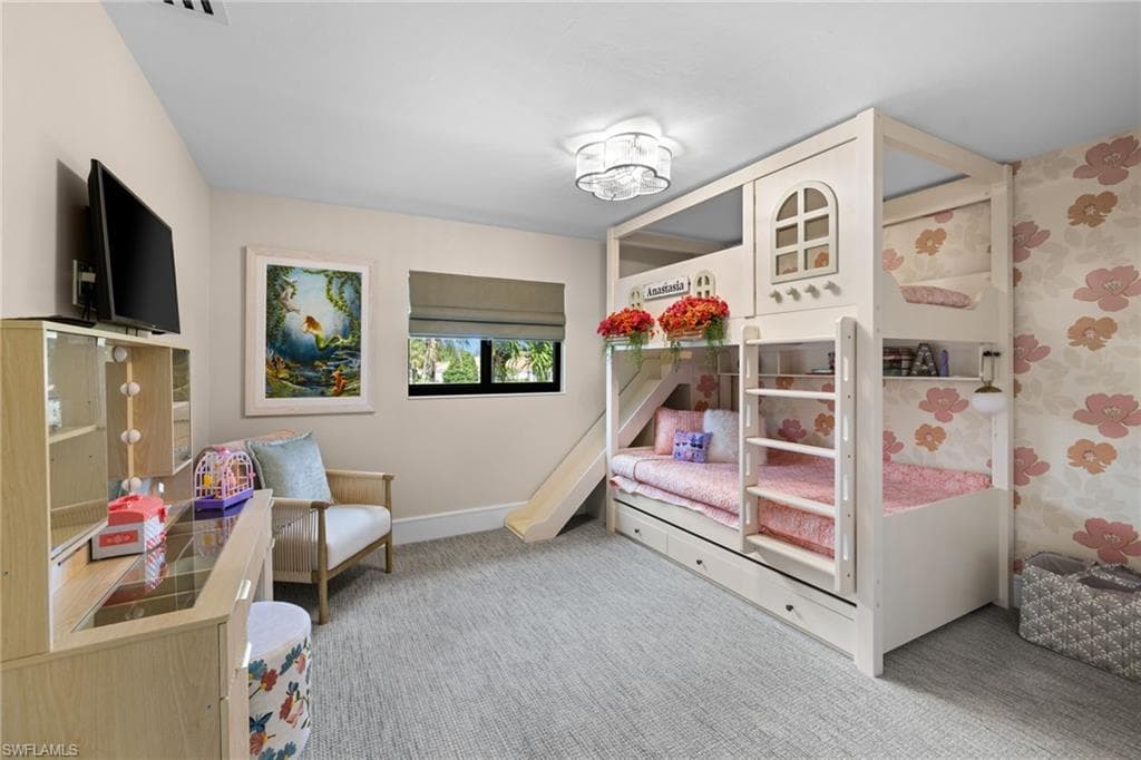 Custom built-in bunk bed structure with a slide and integrated storage