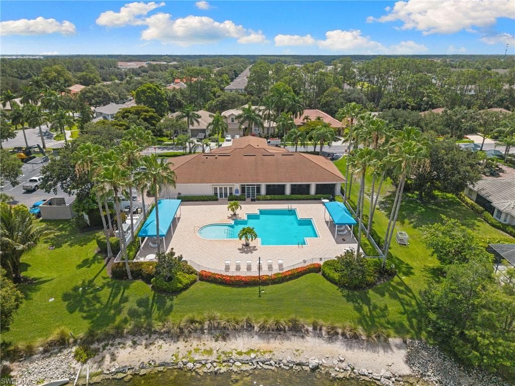 Community pool area featuring a large swimming pool, a smaller wading pool, and a spacious paver deck