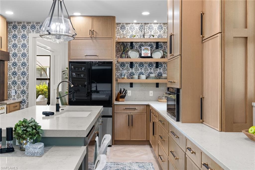 Open-concept kitchen and living area featuring a large center island with a light-colored countertop