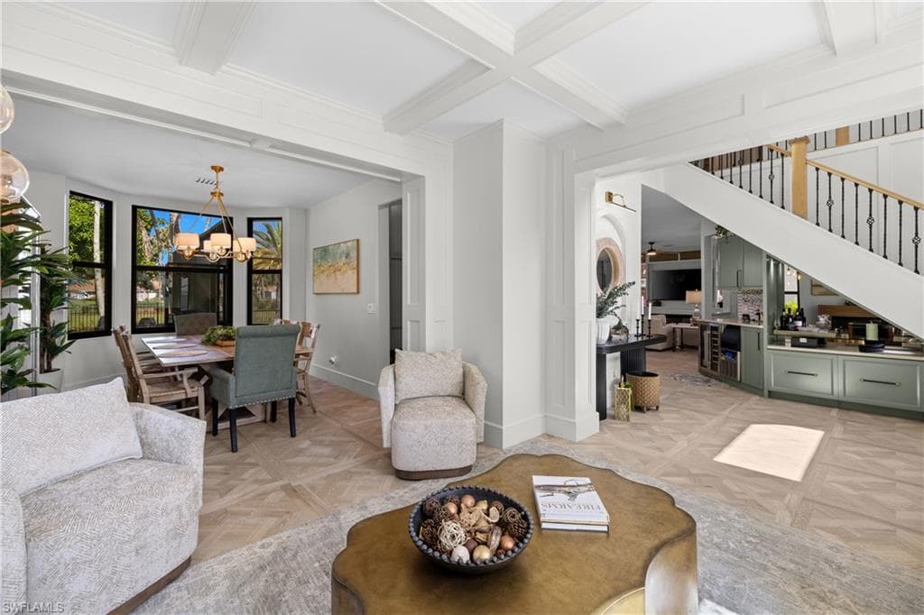 Coffered ceilings complement the wood-finish flooring in a chevron pattern